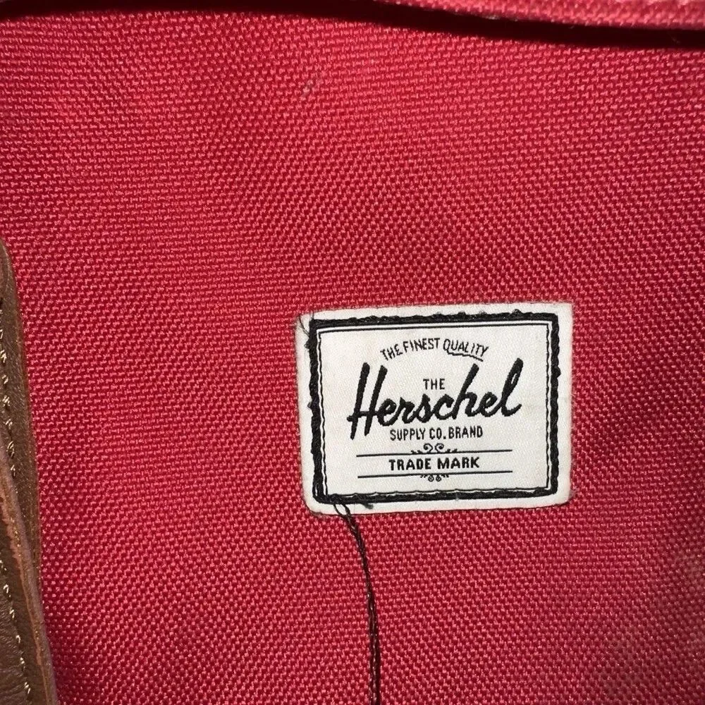 Herschel backpack with pocket. One button is missing, kept it in the front zip.